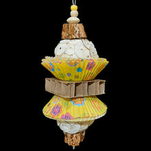 Load image into Gallery viewer, Two super soft sola balls nestled inside colorful paper cupcake liners with a cardboard honeycomb block in the middle and mahogany chunks on both ends. Strung on stainless steel wire with small wood beads and pony beads.
