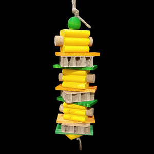 Three layers of brightly colored grooved pine blocks with cork stoppers in the ends, pine slats, cardboard honeycomb blocks and a wood ball strung on heavy jute cord.

Measures approx 3-1/2" wide by 13" including link.